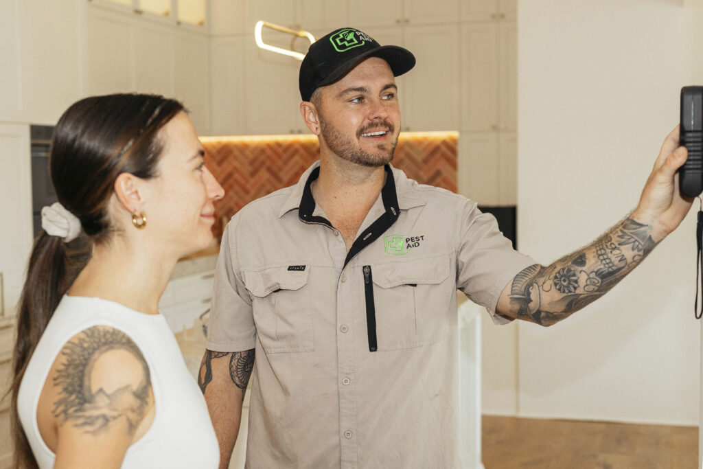 Pest Aid technician with customer